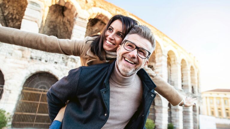 Married couple of tourists walking on city street visiting Italy