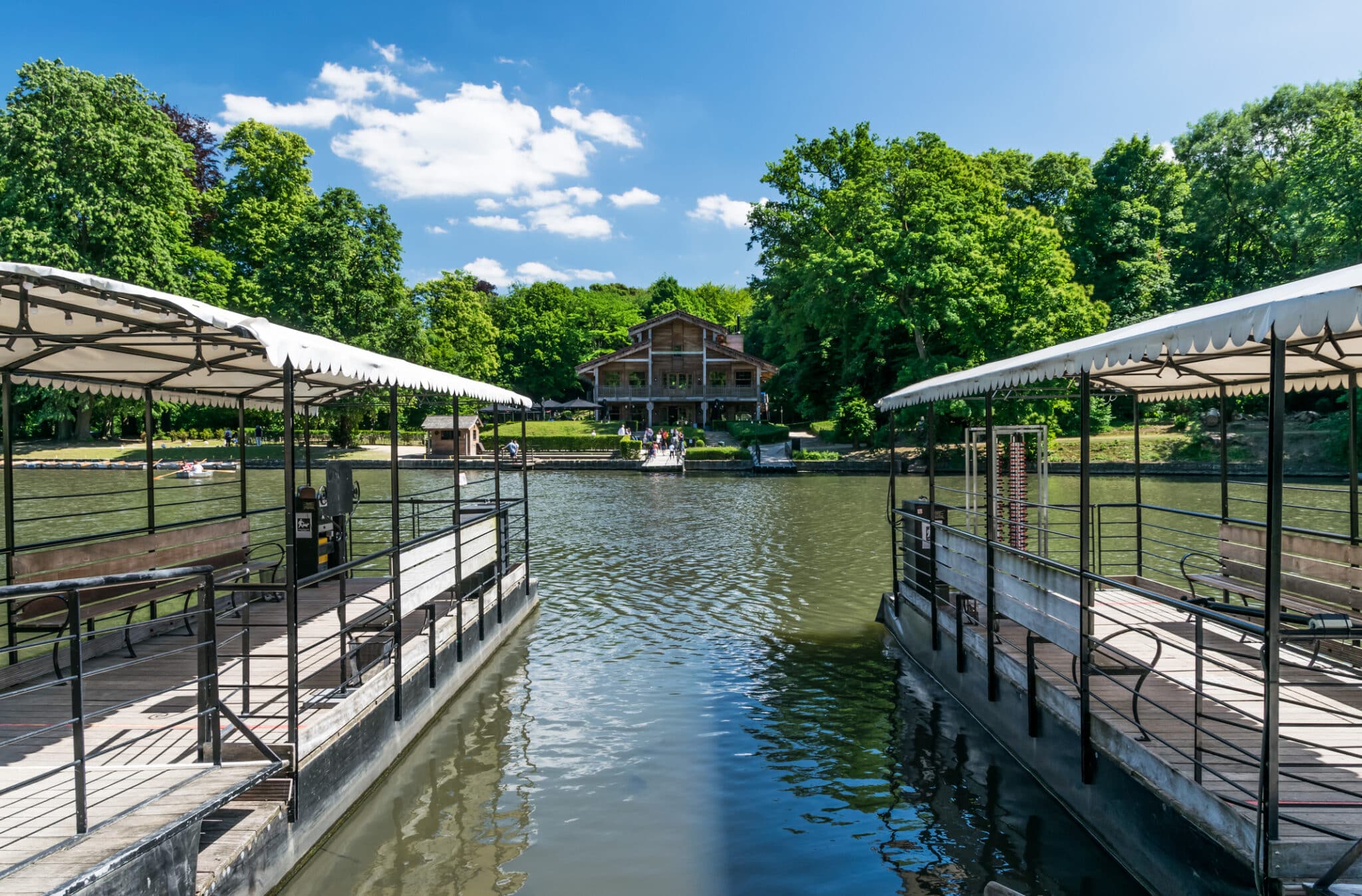 River pier with parasols and bars in the distance.