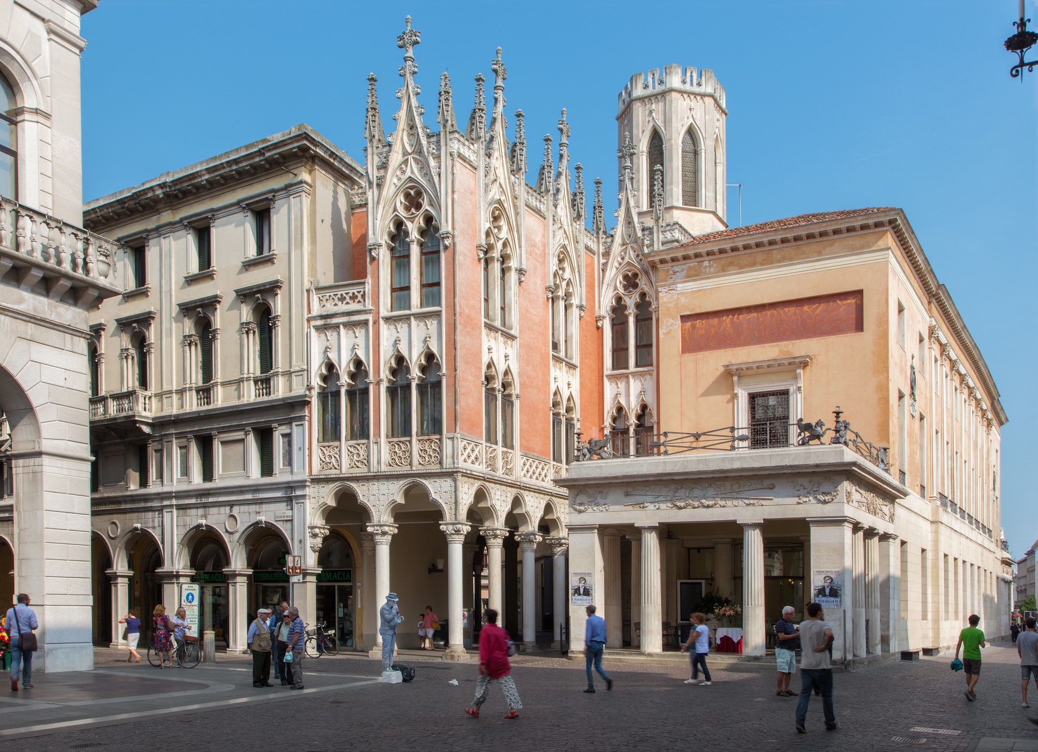 Piazza italiana con architettura gotica e persone.