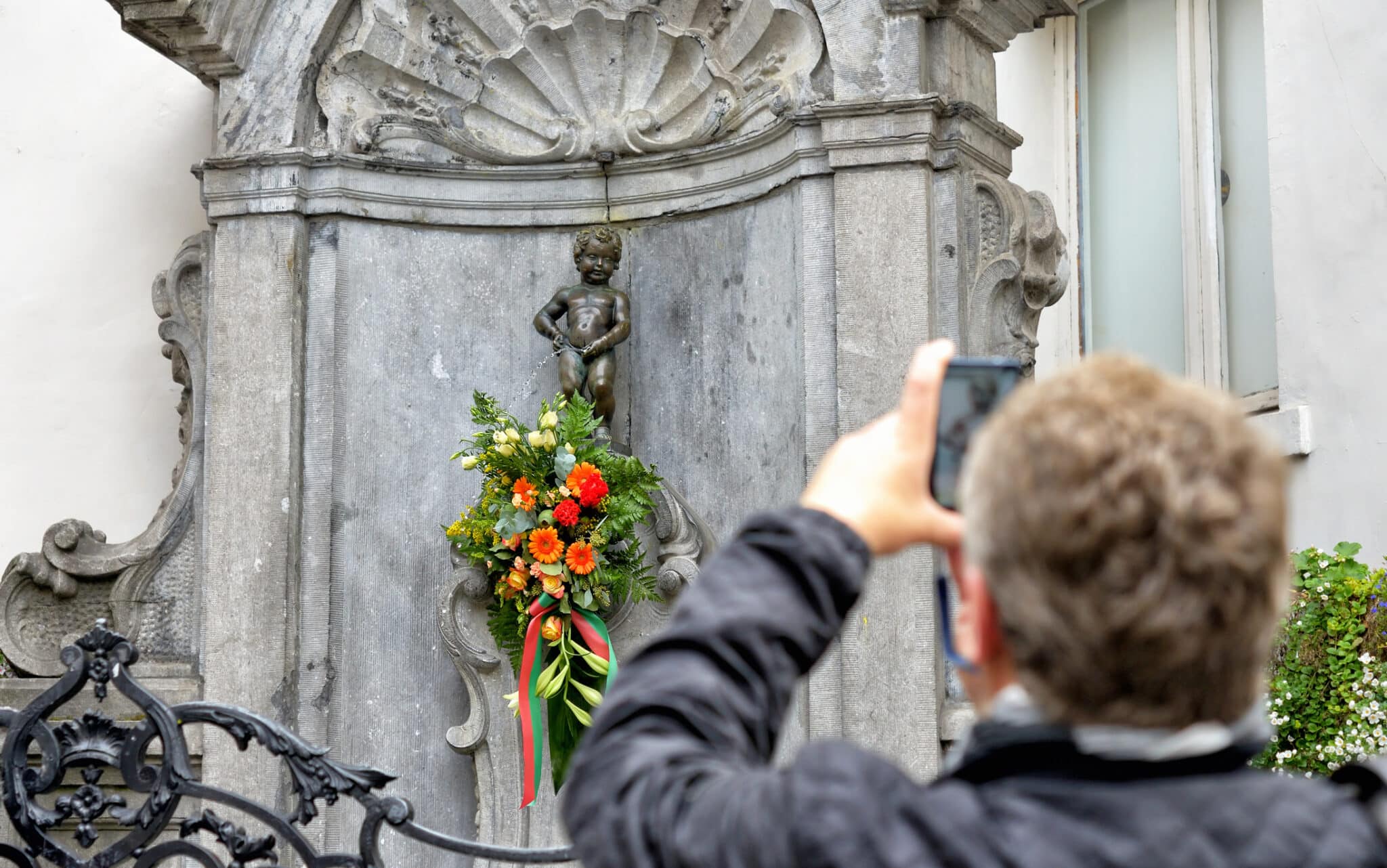 Photographer Manneken Pis decorated in Brussels.