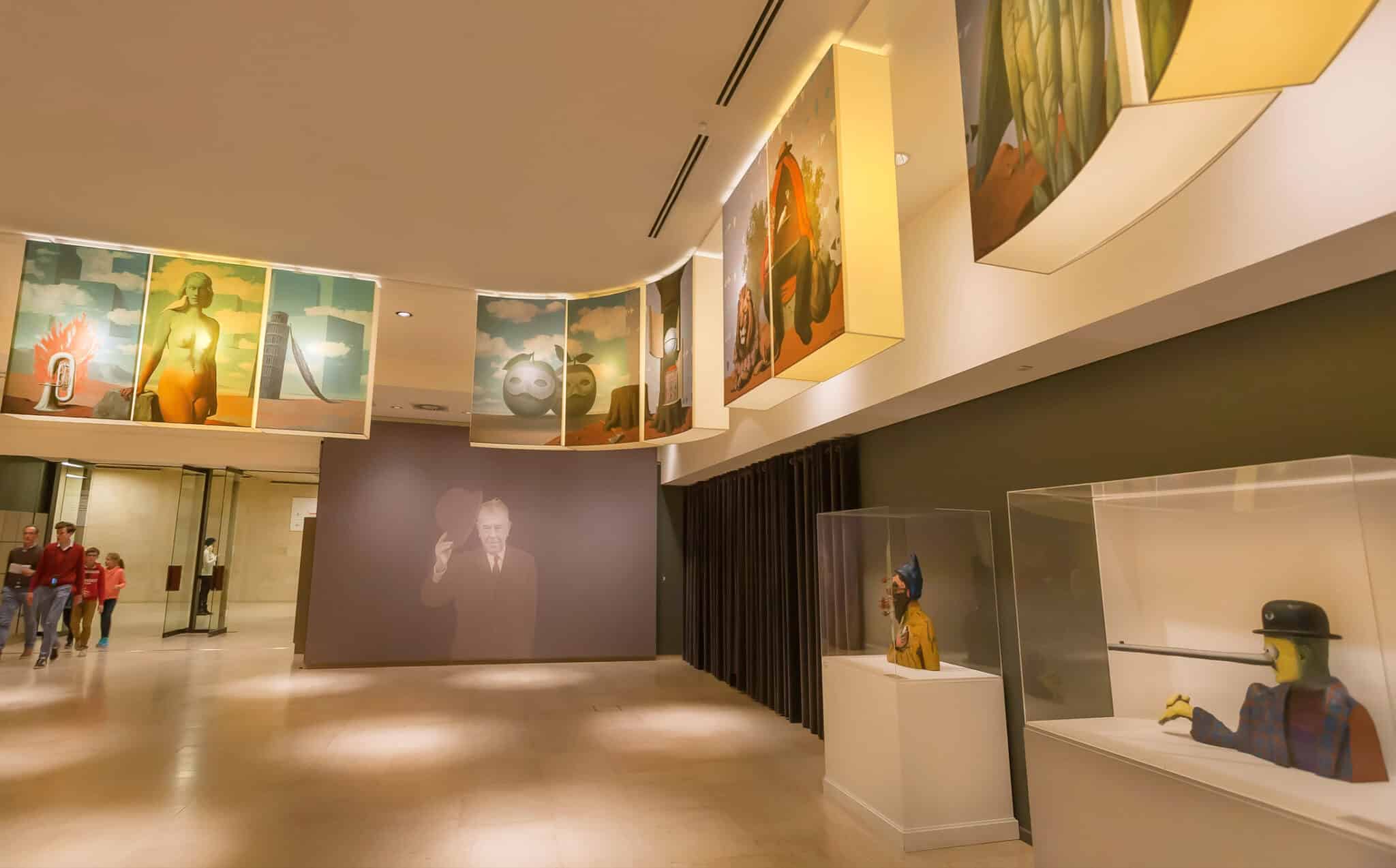 Modern art gallery with visitors and exhibited works.