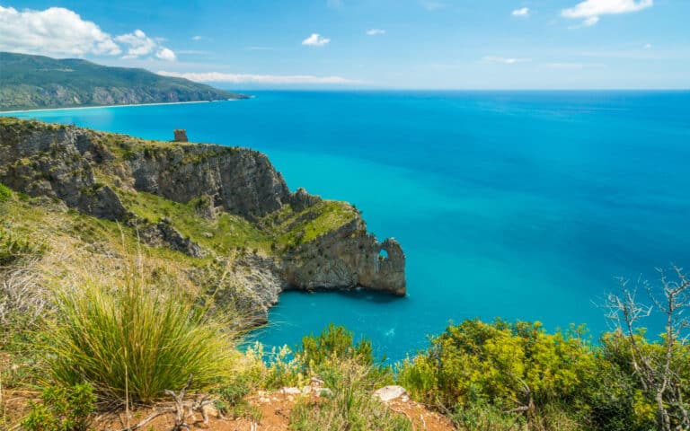 Scogliera e mare azzurro in una giornata soleggiata.