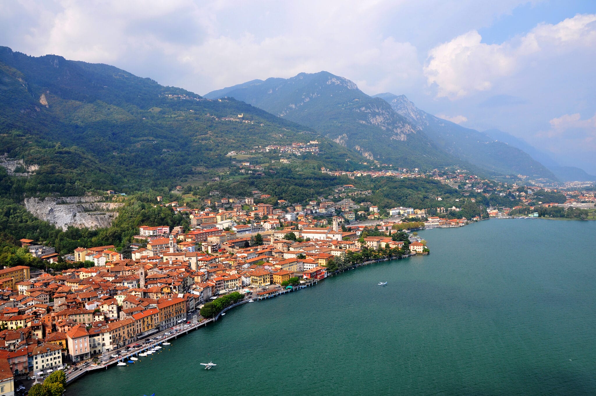 Paysage de lac avec villes et montagnes.