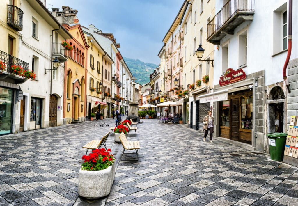 Italian city street with planters and pedestrians