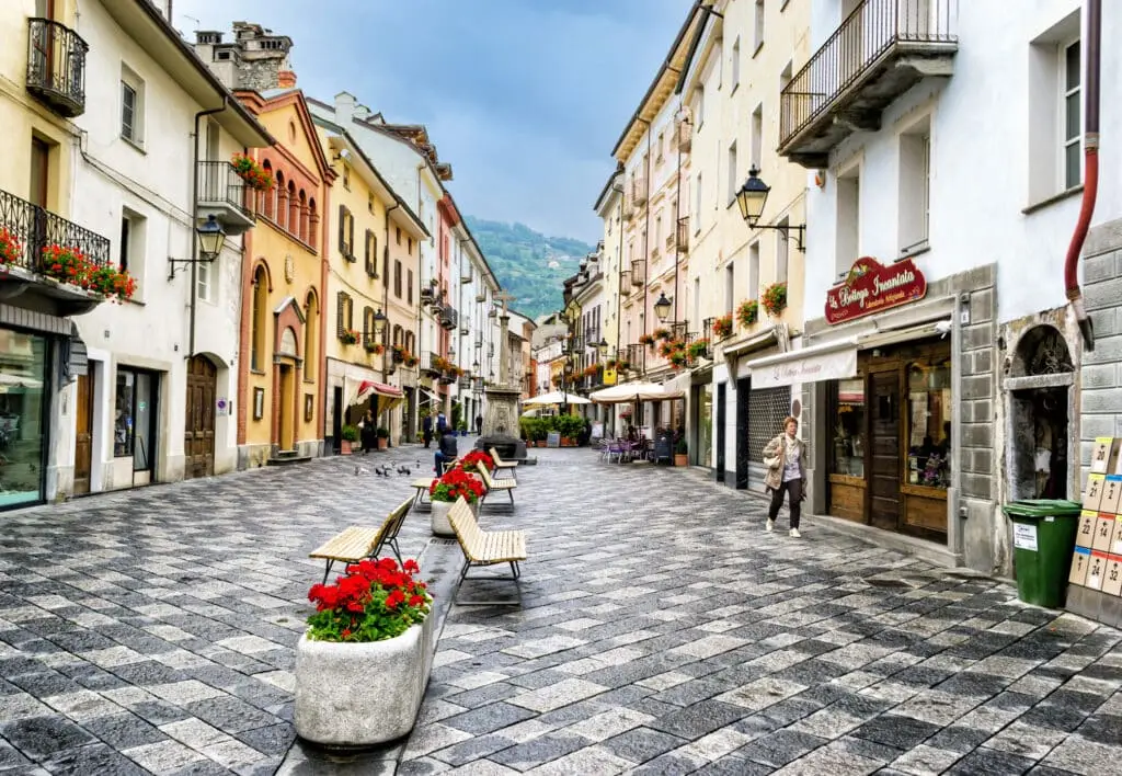 Italienische Stadtstraße mit Pflanzkübeln und Fußgängern