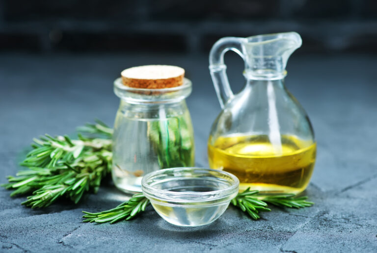 Bottles of oil and fresh rosemary